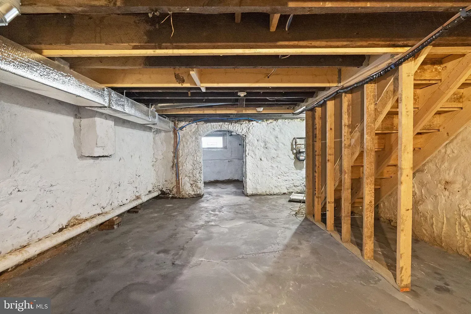 Unit A basement area with exposed framing, concrete floor, and utility ductwork