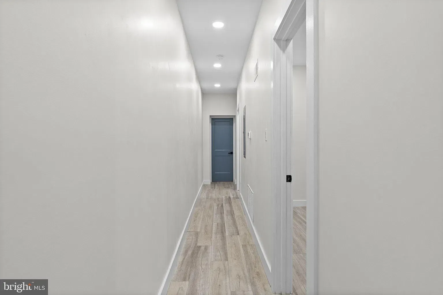 Unit A hallway with recessed lighting and wood-look flooring