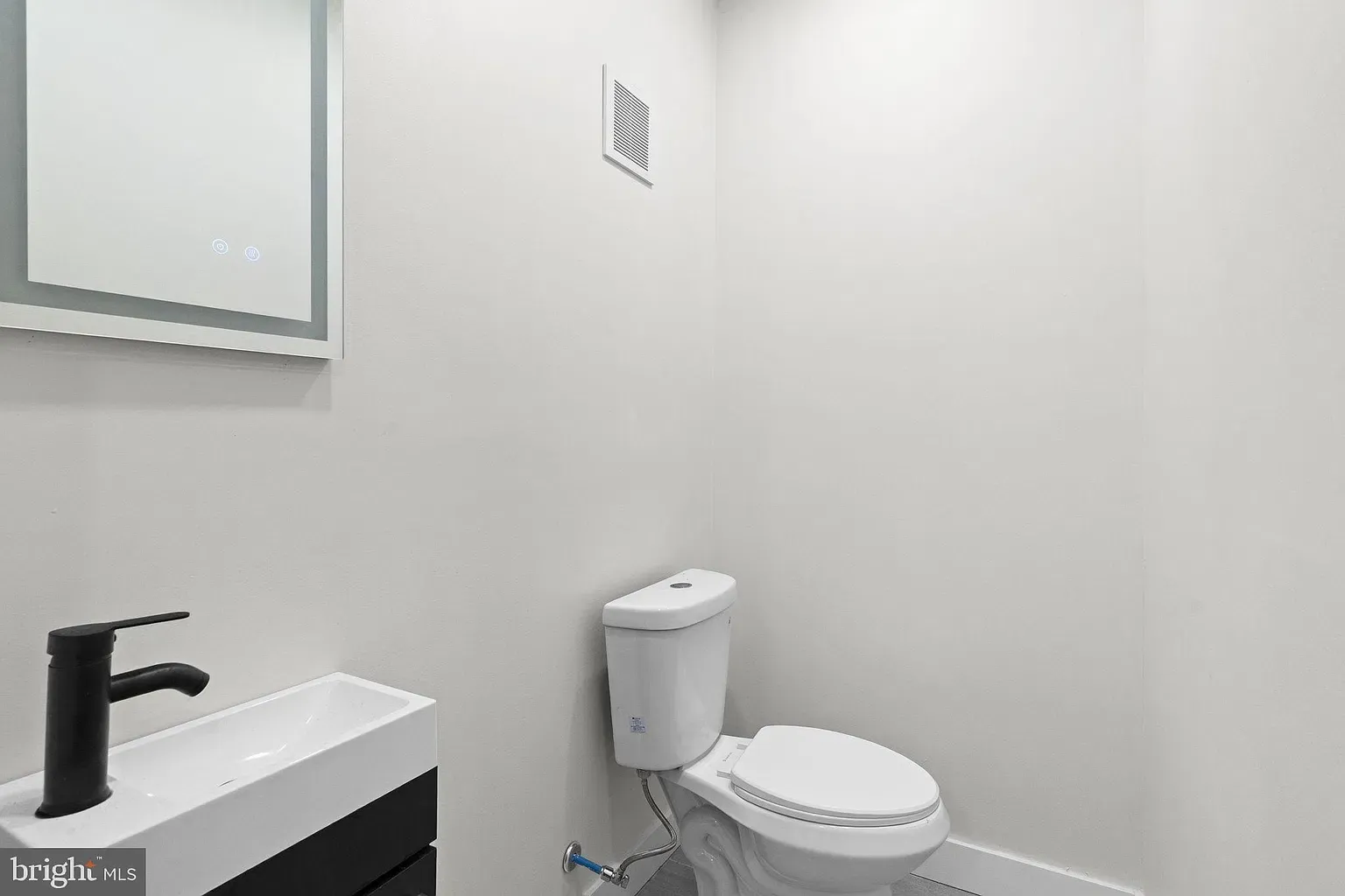 Unit A powder room with a modern vanity and toilet